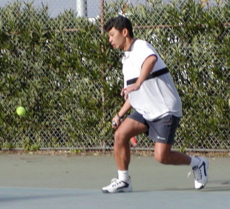 On an open stance, racket held back and low on a western grip to contact the ball with the open-faced racket moving upwards.