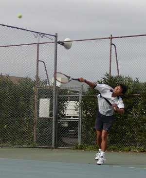 The upper body rotation completed, wrist pronated, and left foot back on the ground regaining balance. Ball is moving away and contact already made